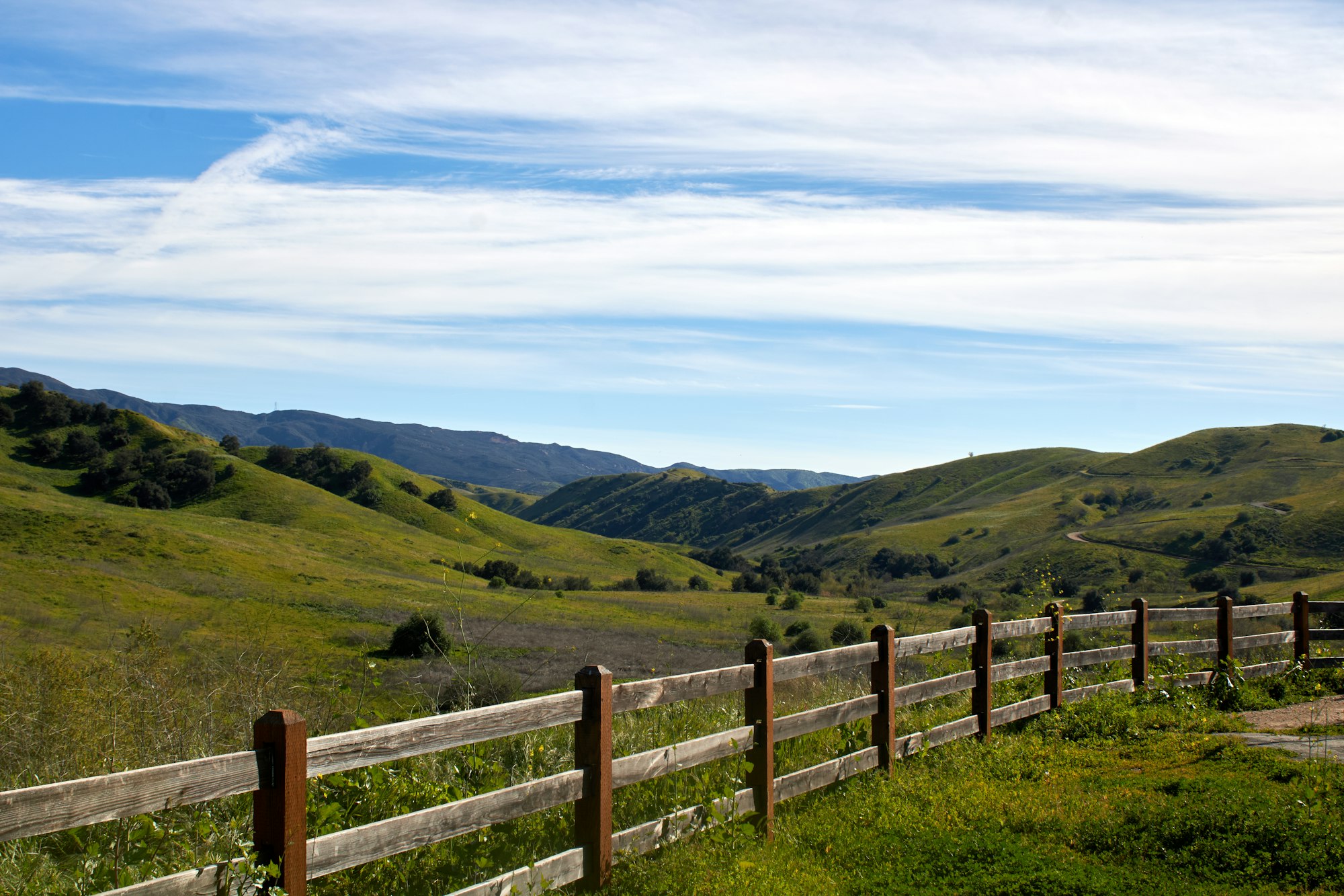 Ranch fence line and rolling green foothills in Amador County